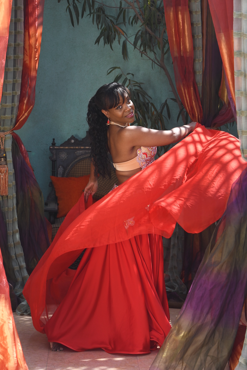 Kim Maria in red costume with red veil